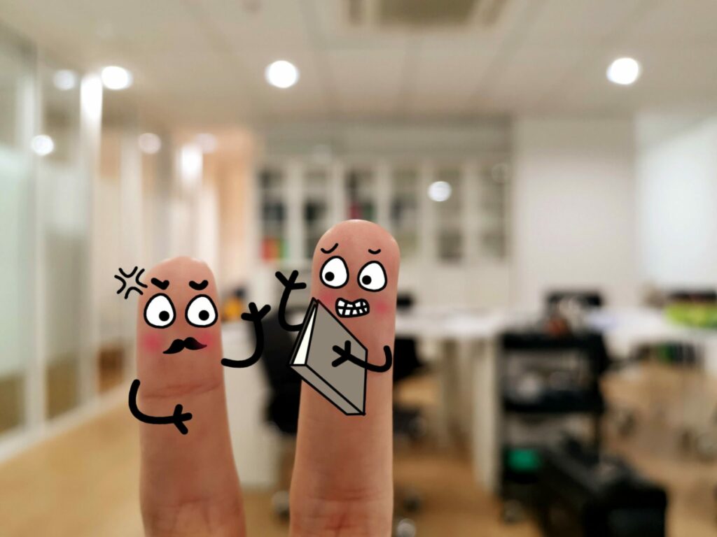 Two fingers are decorated as two person in the office. The boss is asking his worker to redo his report.