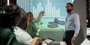 Management team sharing insight on statistics in night corporation meeting, providing initiatives to enhance operational data.