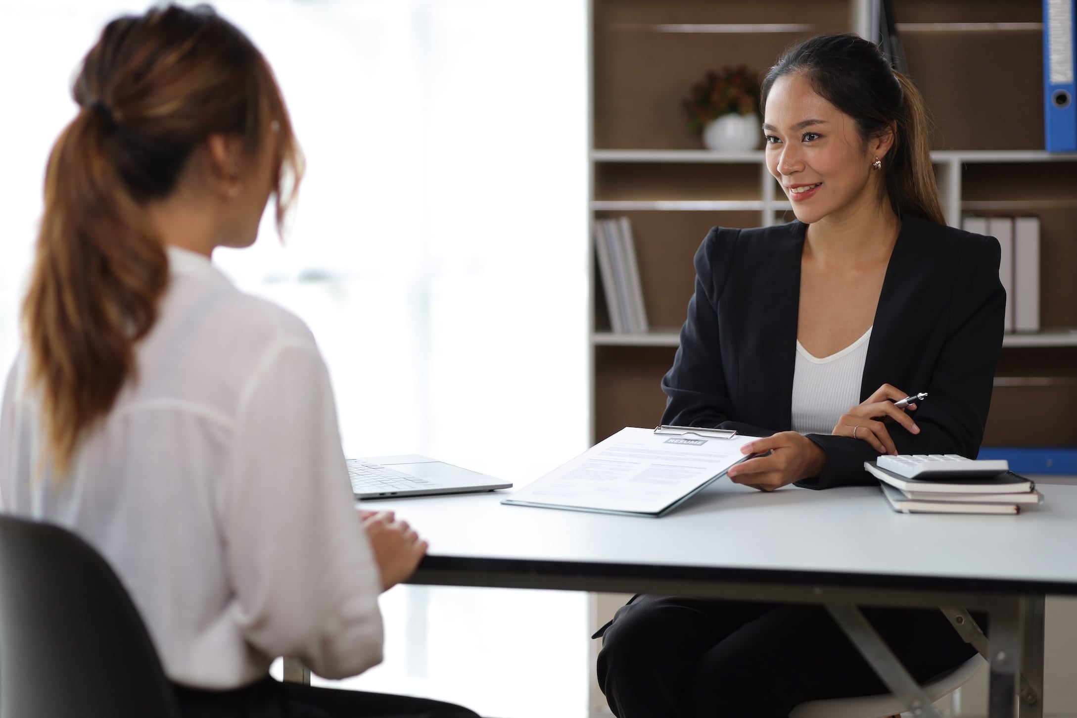 Latina small business owner interviewing a job applicant