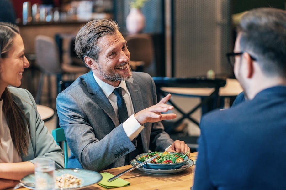 Smiling group of diverse businesspeople working together around a meeting table
