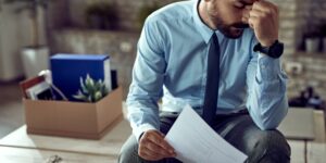 Young frustrated businessman holding his head