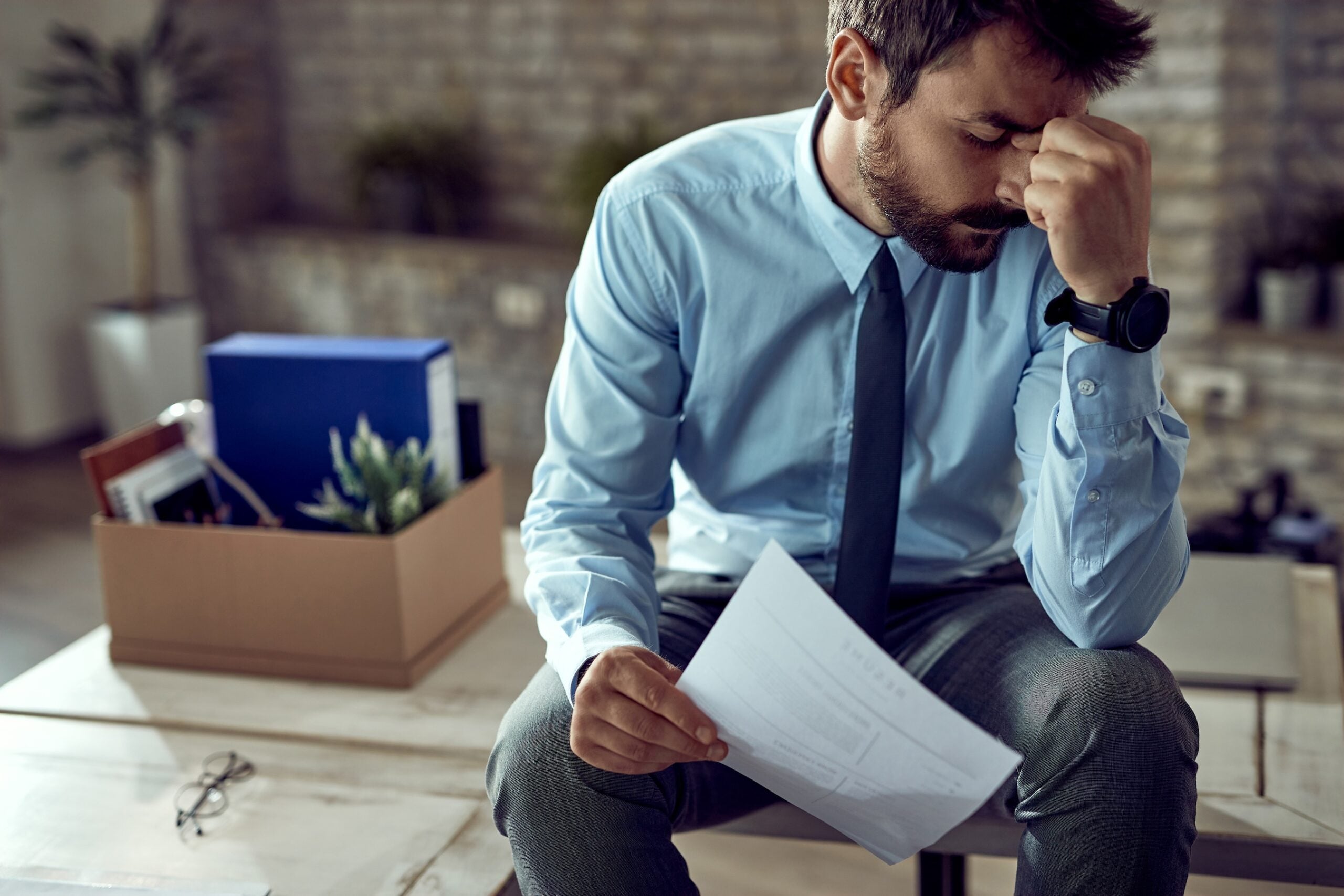 Young frustrated businessman holding his head
