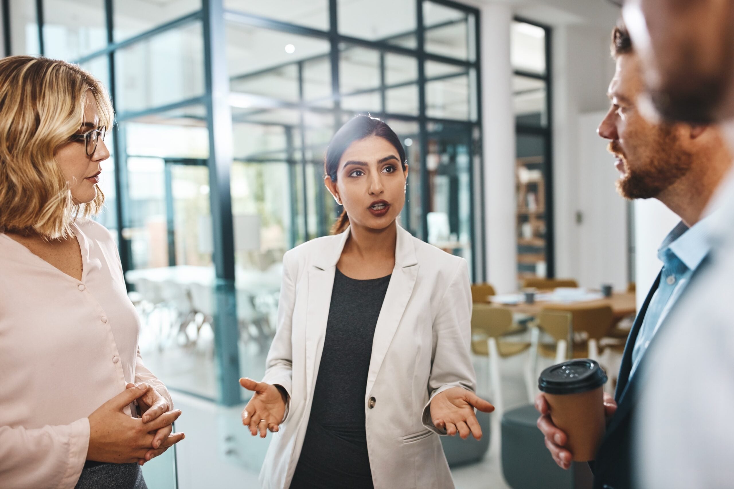 Woman, business people or talking to meeting in modern office for team