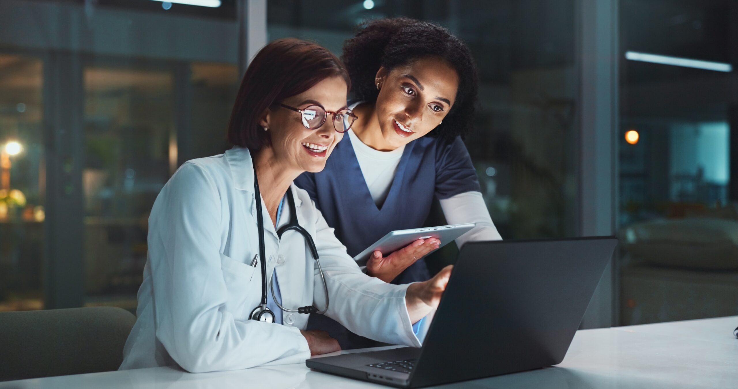 Night, doctor and nurse on laptop